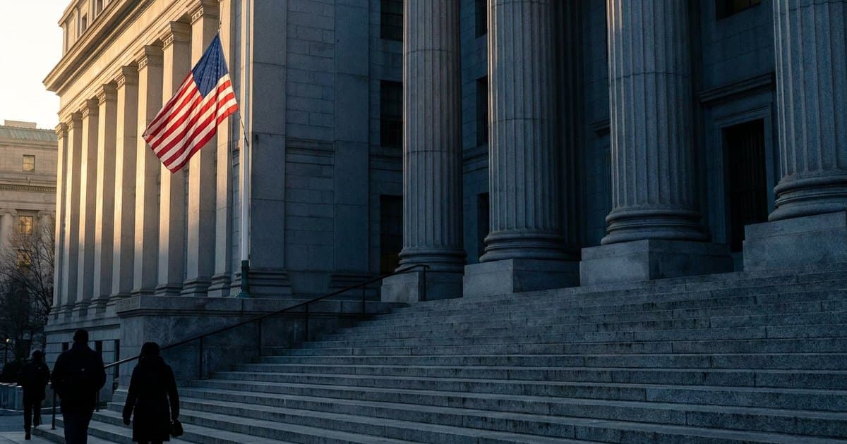 The columns and steps of a federal courthouse with an American flag