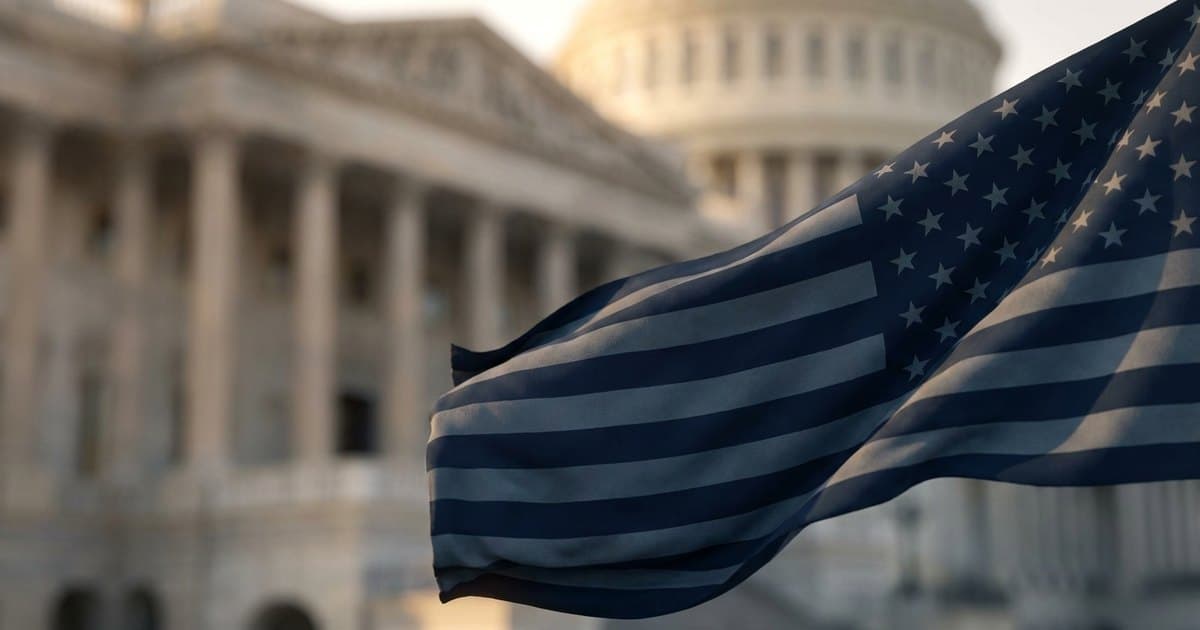 An American flag in warm light before a government building